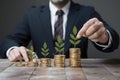 Man putting golden coins on board representing multiple streams of income