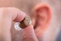 Man Putting Hearing Aid In His Ear Royalty Free Stock Photo