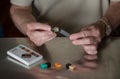 Man putting JUUL nicotine dispenser together with flavor pods