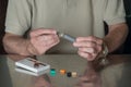 Man putting JUUL nicotine dispenser together with flavor pods Royalty Free Stock Photo