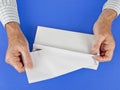 Man putting letter into white envelope Royalty Free Stock Photo