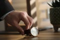 Man putting luxury wrist watch on table, closeup Royalty Free Stock Photo