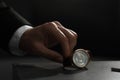 Man putting luxury wrist watch on table, closeup Royalty Free Stock Photo