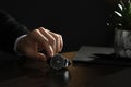 Man putting luxury wrist watch on table, closeup. Space for text Royalty Free Stock Photo