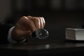 Man putting luxury wrist watch on table, closeup. Space for text Royalty Free Stock Photo