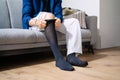 Man Putting On Medical Compression Stockings Royalty Free Stock Photo