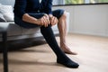 Man Putting On Medical Compression Stockings Royalty Free Stock Photo