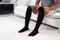 Man Putting On Medical Compression Stockings Royalty Free Stock Photo