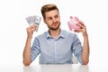 Man putting money in piggy bank Royalty Free Stock Photo