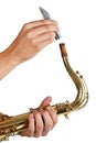 Man putting the mouthpiece back on the saxophone