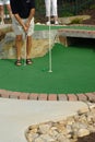 Man putting on a Putt Puut course. Royalty Free Stock Photo