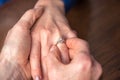 Man putting a ring on woman's finger Royalty Free Stock Photo