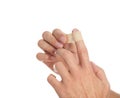 Man putting sticking plaster onto finger on white, closeup Royalty Free Stock Photo