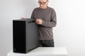 Man putting to table heavy PC case, weight 15,8 kg, empty big tower, chassis Royalty Free Stock Photo