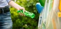 Man putting twisted bottle into trash can. Royalty Free Stock Photo