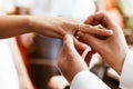 Man putting wedding ring on woman finger. Exchange Wedding rings. happy groom and bride. Wedding day concept Royalty Free Stock Photo