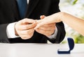 Man putting wedding ring on woman hand Royalty Free Stock Photo