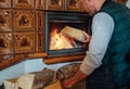 Man putting wood logs in the home mantel fire.Home sweet home and winter countryside holidays concept image Royalty Free Stock Photo