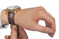 Man putting on wrist watch. Isoalted on black background