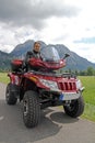 A man on quad before the mountains in Bavaria Royalty Free Stock Photo