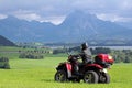A man on quad before the mountains in Bavaria Royalty Free Stock Photo