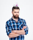 Man in queen crown standing with arms folded