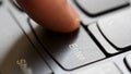 Man quickly pressing the enter key on a modern laptop computer keyboard, macro detail extreme closeup, shallow DOF, one person.