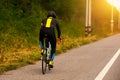 Man cycling on the street viewed from behind