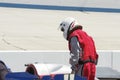 Man in race suit on pit row with IRL car Royalty Free Stock Photo