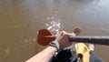 Man on raft paddles in river. Clip. First-person view of quiet muddy river rafting in spring. Quiet single river rafting