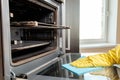 Man with rag cleaning kitchen stove Royalty Free Stock Photo