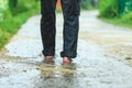 A man in the rain is barefoot in puddles Royalty Free Stock Photo