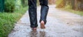 A man in the rain is barefoot in puddles Royalty Free Stock Photo