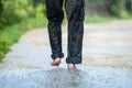 A man in the rain is barefoot in puddles Royalty Free Stock Photo
