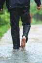 A man in the rain is barefoot in puddles Royalty Free Stock Photo