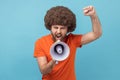 Man raised hands and holding megaphone, screaming in loud speaker, protesting. Royalty Free Stock Photo