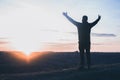 A man with raised hands is praying. On the background of the sunset sky. Repentance for sins. Kneeling Prayer to God. Worship Royalty Free Stock Photo