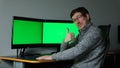 man raised his thumb up class he likes his work two computer screens with green screen glasses Green Mock-up Screen