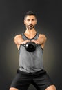 Man raising and extending a kettlebell weight