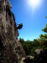 Man rappeling down basalt rock on a sunny day in a California park Royalty Free Stock Photo