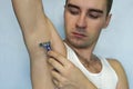 Man with razor while shaving armpits Royalty Free Stock Photo