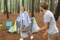 man reaching out hand to woman while playing badminton outdoors Royalty Free Stock Photo