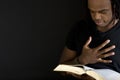 Man reading a bible isolated on black. Royalty Free Stock Photo