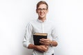 Man reading Bible, white background, book in hand close-up