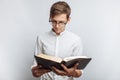 Man reading Bible, white background, book in hand close-up