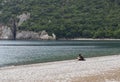 Man is reading a book on the beach near ancient town Olimpos Royalty Free Stock Photo