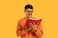 Man reading a book with interest and glasses Royalty Free Stock Photo