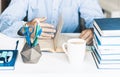 Man reading book on modern stylish work place with office supplies, glasses, notebooks and books, desk work concept in white and Royalty Free Stock Photo