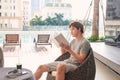 Man reading book near swimming pool. Relax concept Royalty Free Stock Photo