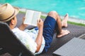 Man reading book near swimming pool. Relax concept. Royalty Free Stock Photo